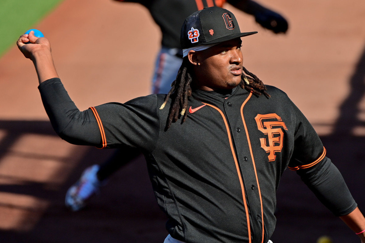 SF Giants pitcher Melvin Adon throws a weighted practice ball during a Spring Training workout at Scottsdale Stadium. (2023)